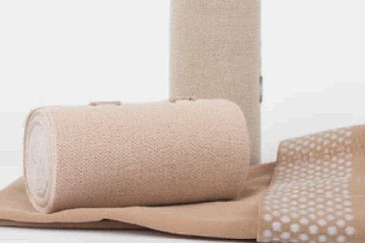 two rolls of bandages are sitting on top of each other on a table