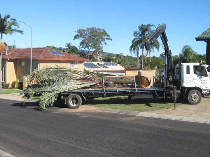 A white truck with a crane on the back of it