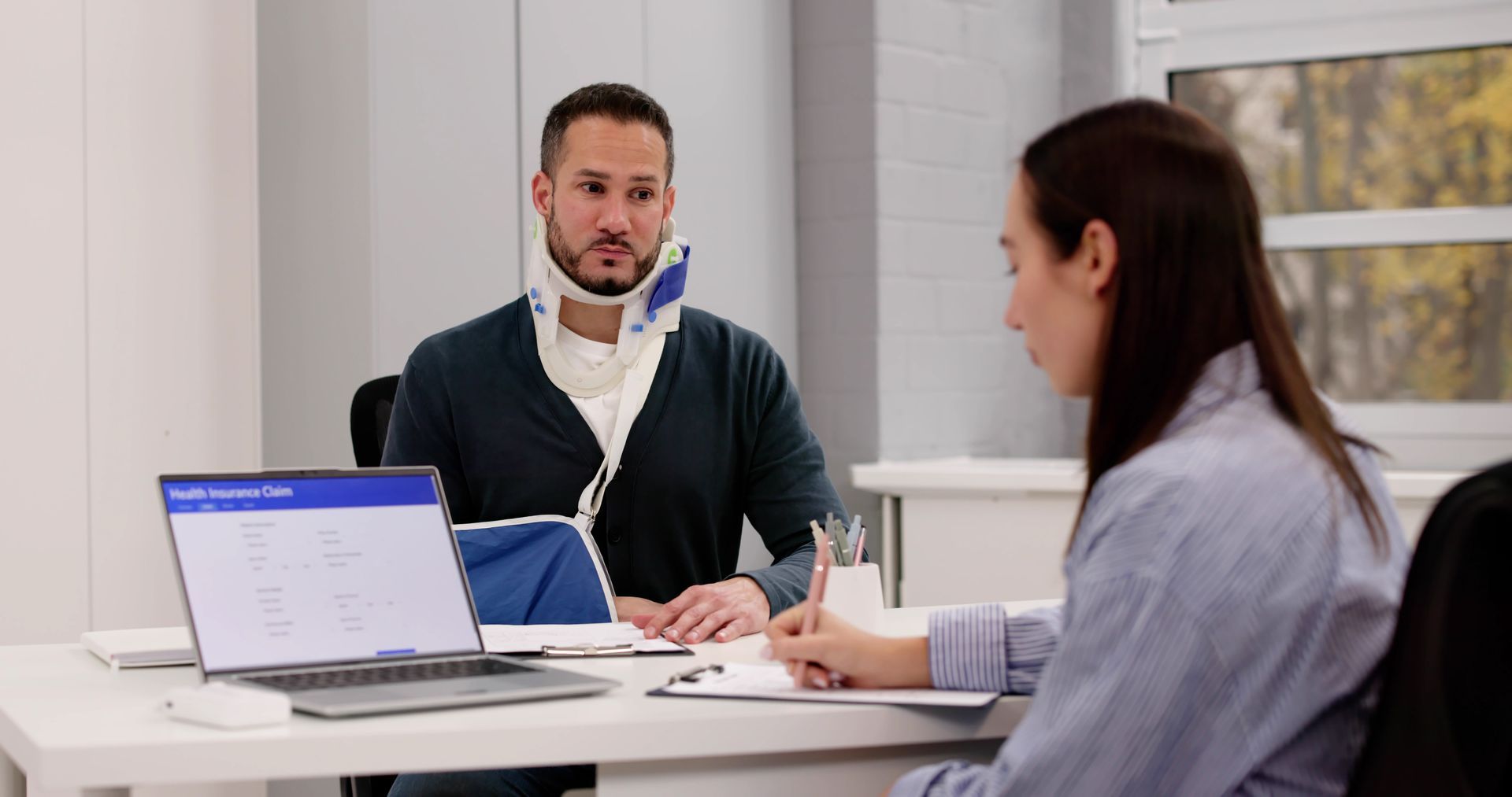 Social Security Disability Lawyer reviewing case documents with a client.