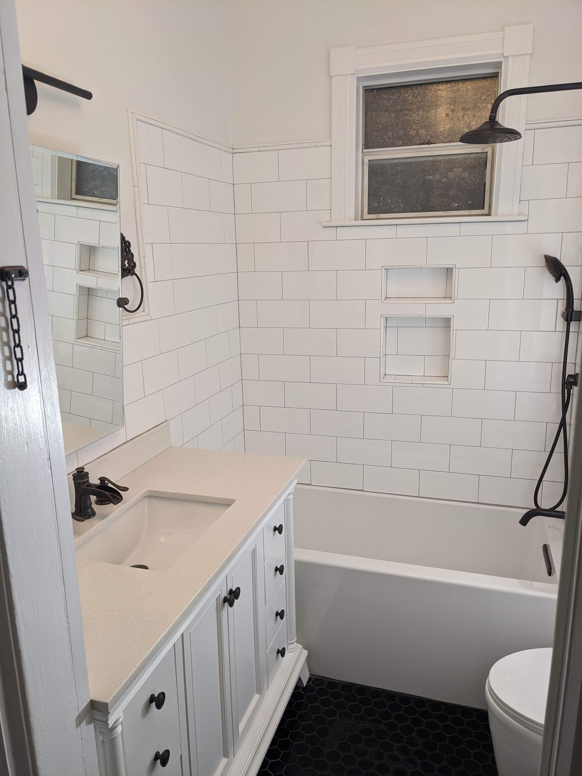 A bathroom with a sink , toilet , tub and shower.