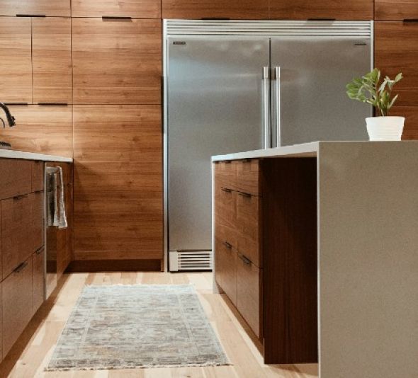 A kitchen with stainless steel appliances and wooden cabinets