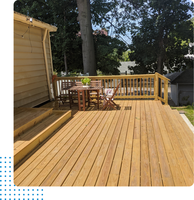 A wooden deck with a table and chairs on it