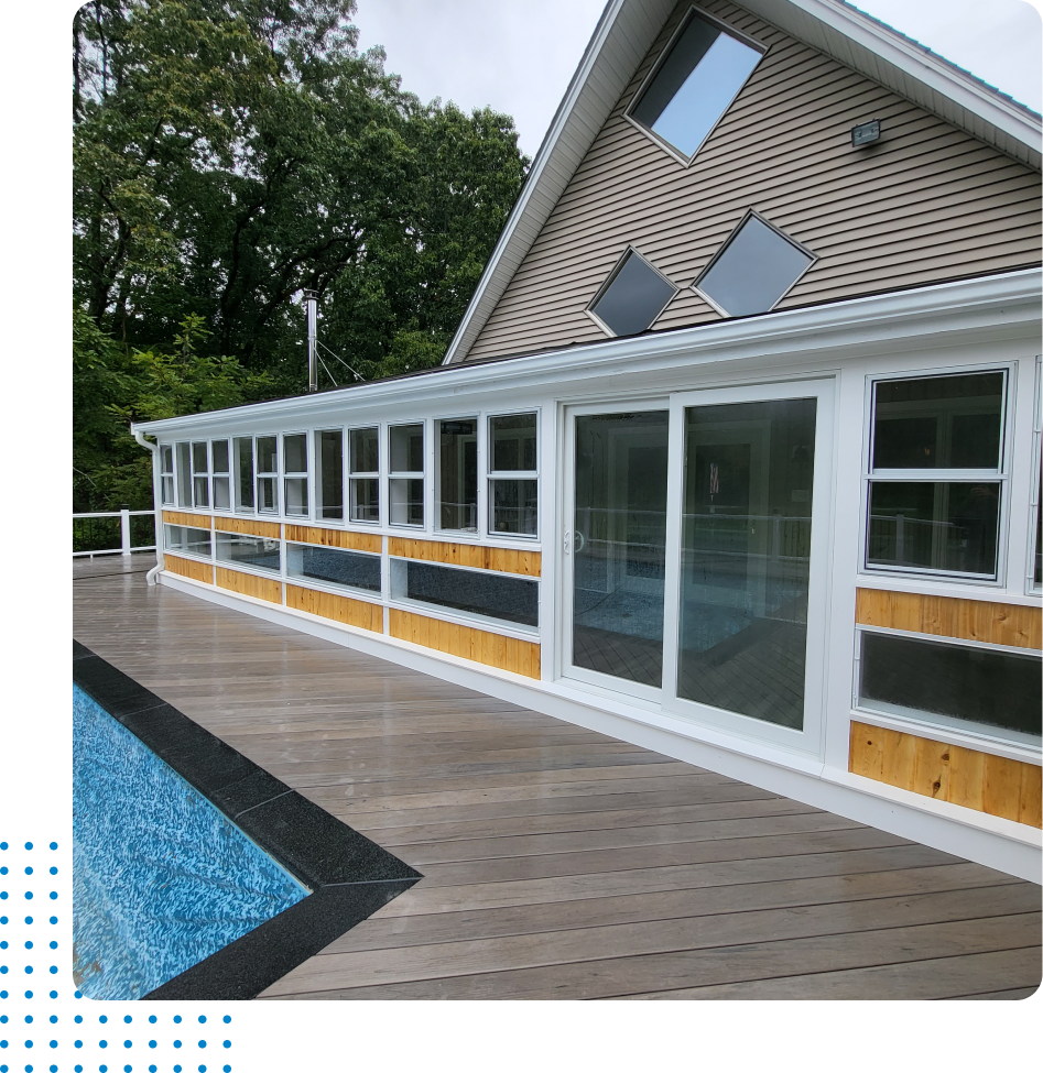 A large house with a swimming pool in front of it