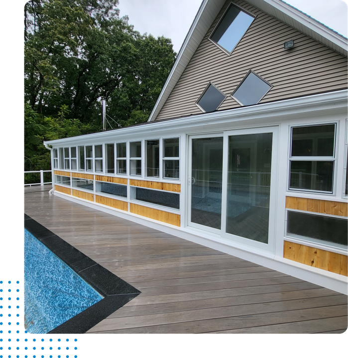 A large house with a swimming pool in front of it