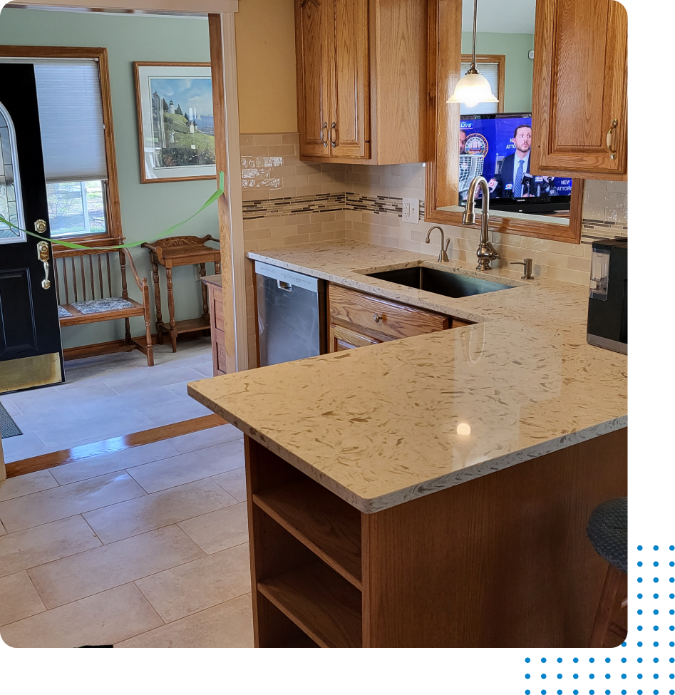 A kitchen with granite counter tops and wooden cabinets