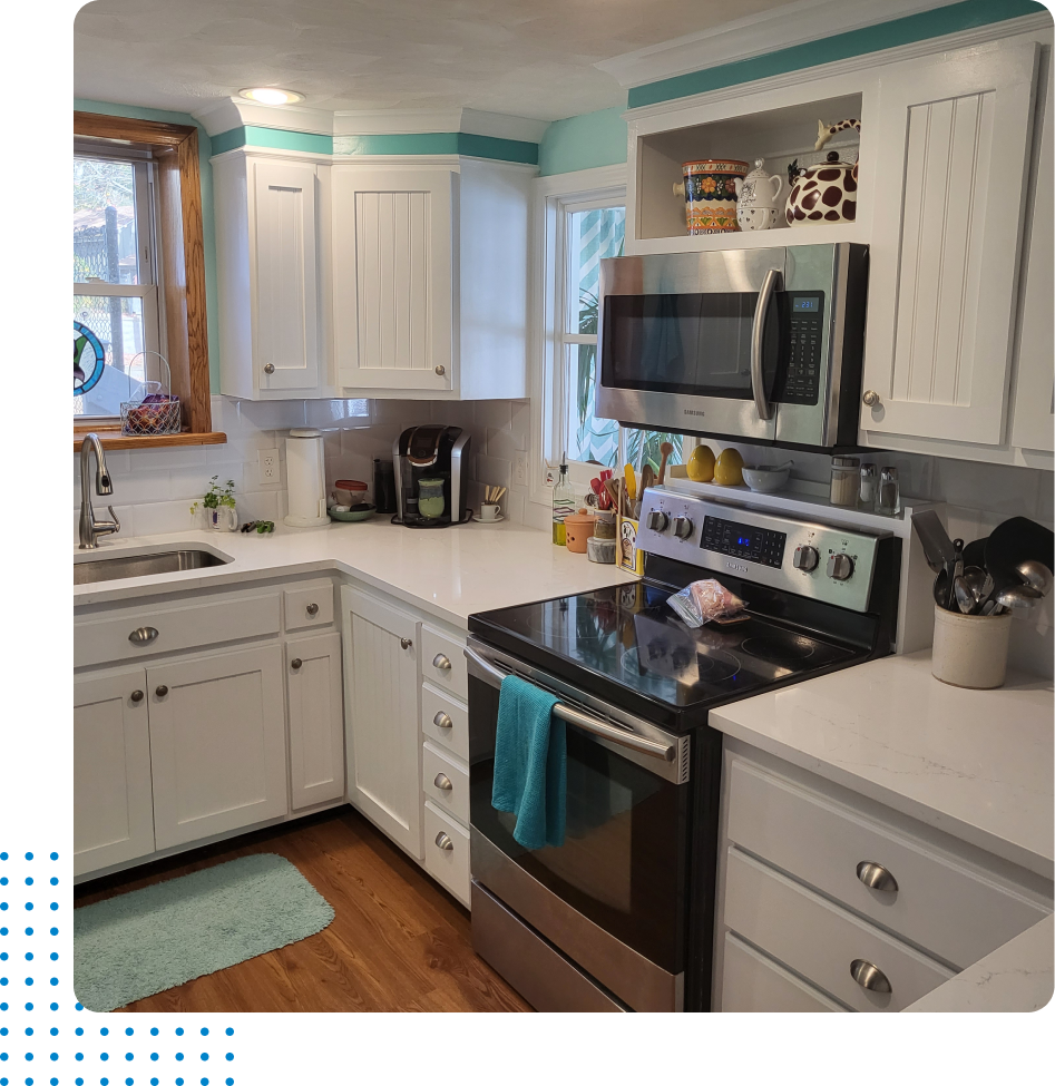 A kitchen with stainless steel appliances and white cabinets
