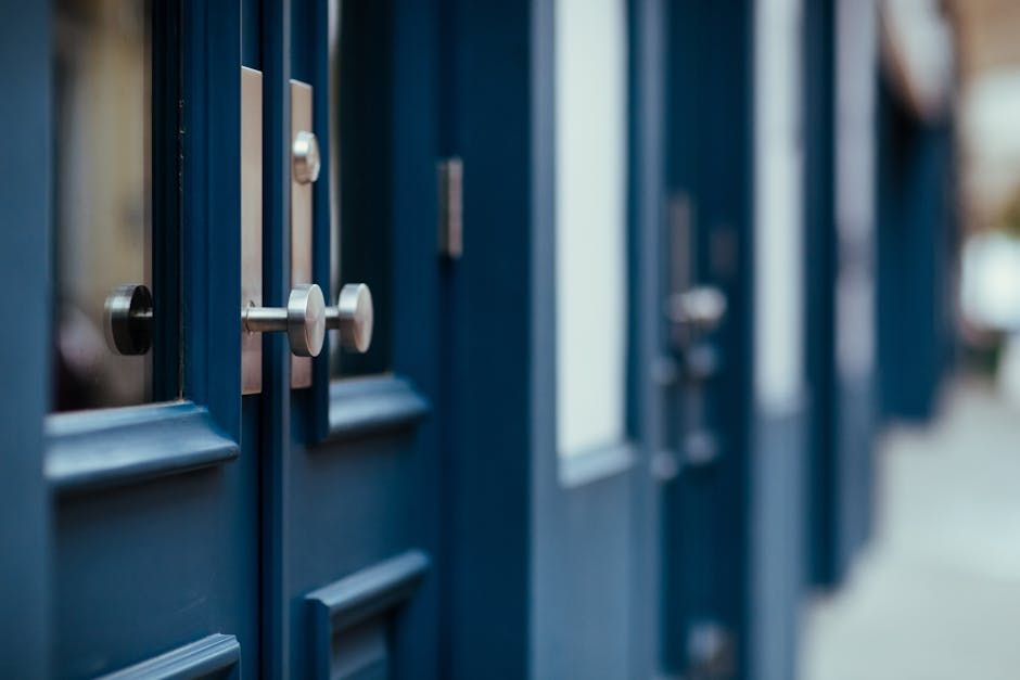 Blue doors with silver handles in a row, slightly out of focus.