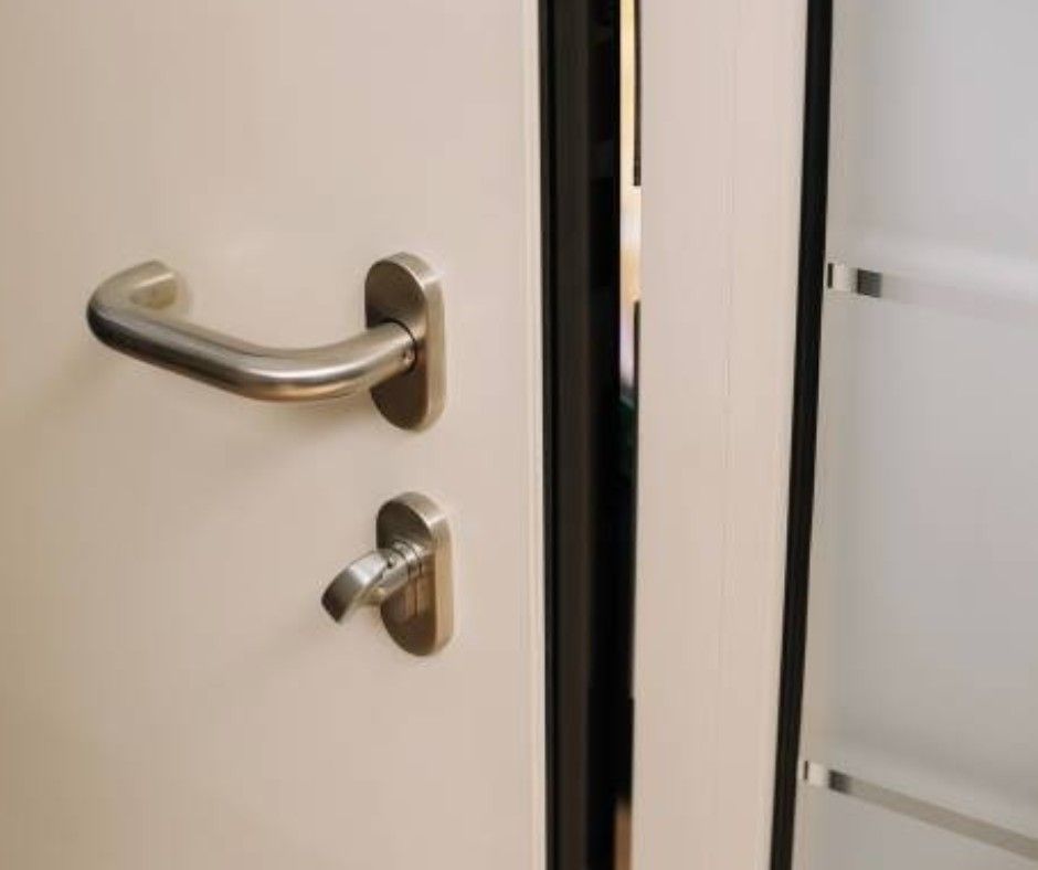 White door with brushed metal handle and privacy lock.