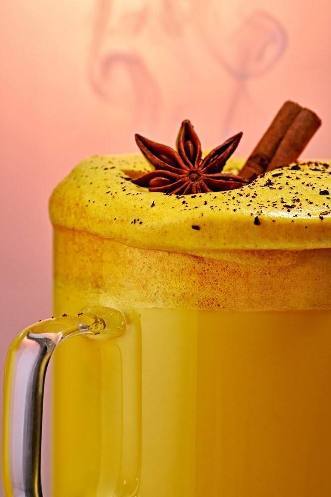 Golden turmeric latte topped with star anise and cinnamon stick. Food Stylist Nadine Page.