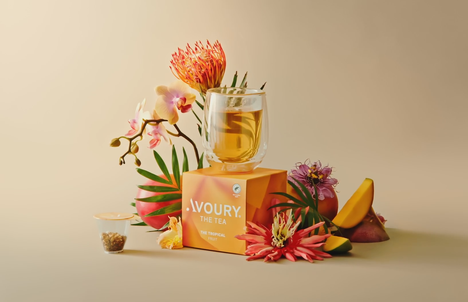 A glass of tea sits atop an orange box labeled