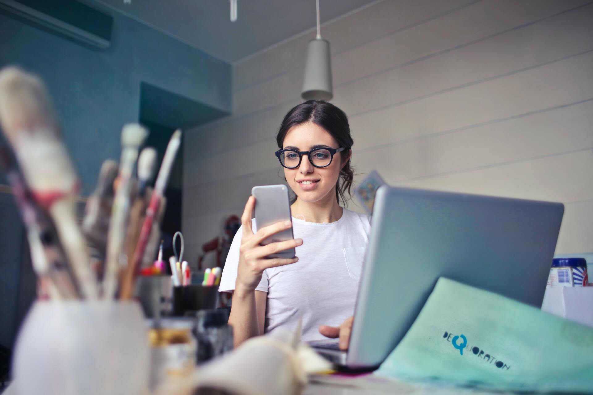 Woman using App whilst working at laptop, Urbandog Media