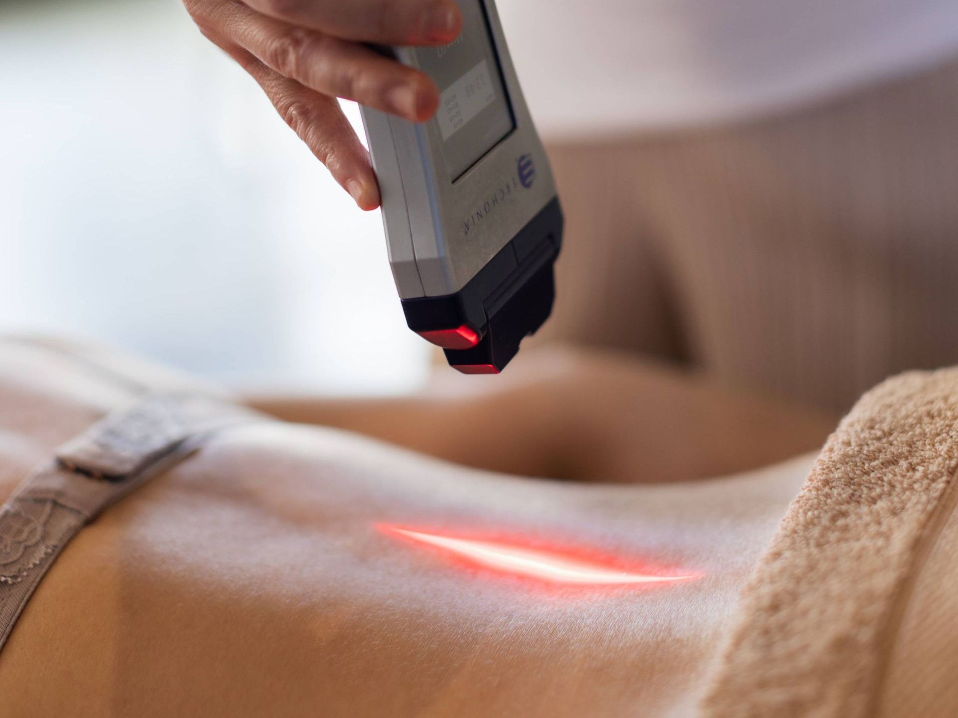 a person is getting a laser treatment on their back