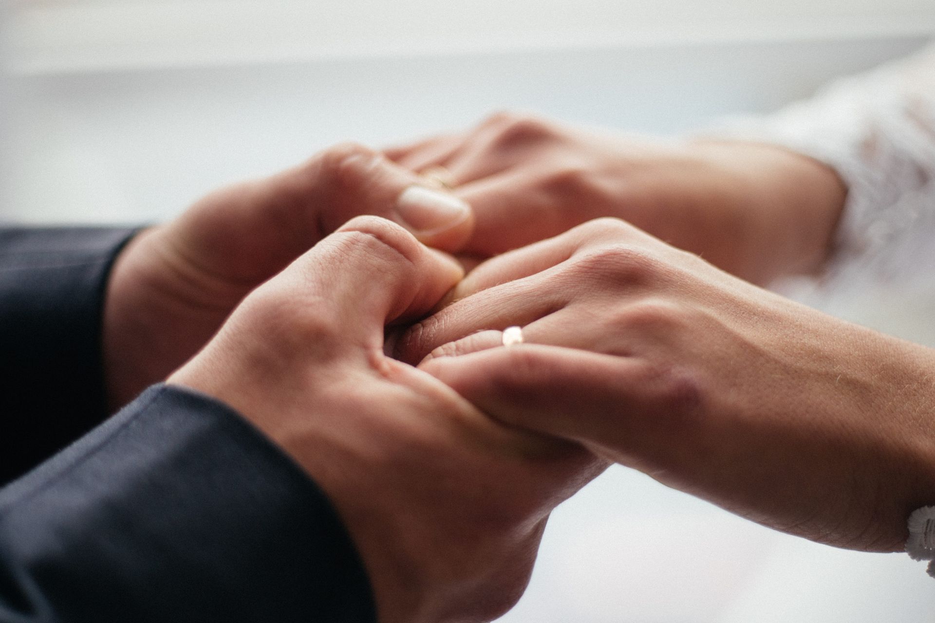 Hands exchanging a ring in a close-up wedding ceremony