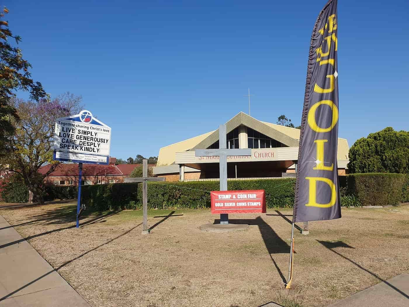 A For Sale Sign Is In Front Of A Church — John Platts Stamps & Coins In Mackay, QLD