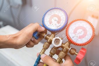 A person is holding a couple of gauges in their hands.
