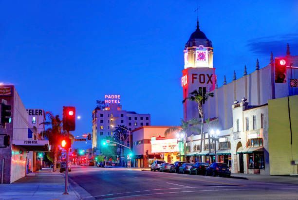A city street at night of Bakersfield Fox theatre in the background