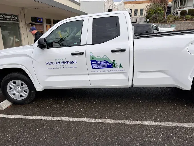 Gray truck with ladder, side graphics for