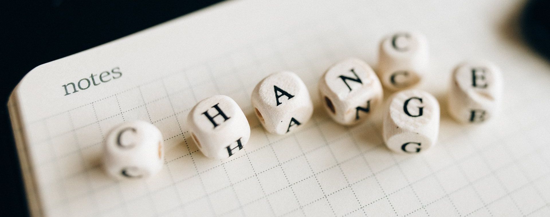 A row of dice with the word change written on them.