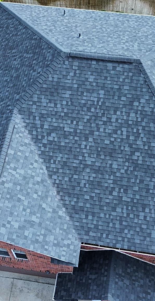 An aerial view of a house with a gray roof.