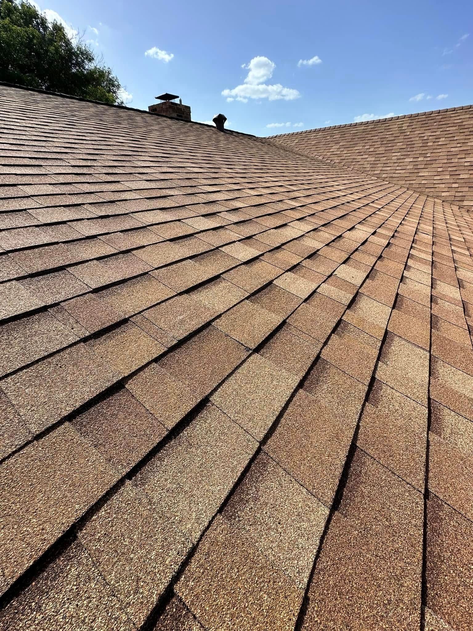 A close up of a roof with a blue sky in the background.