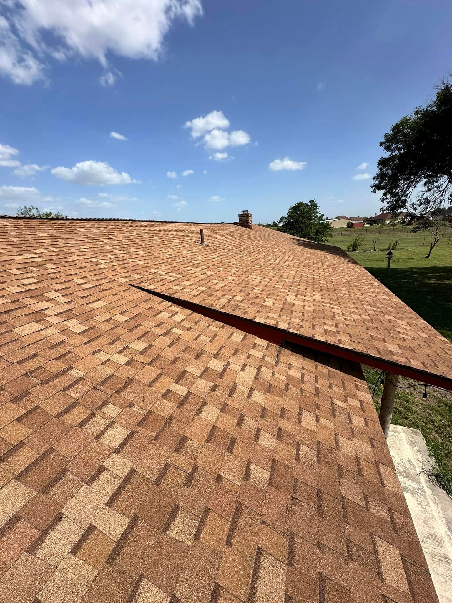 A close up of a roof with a blue sky in the background.
