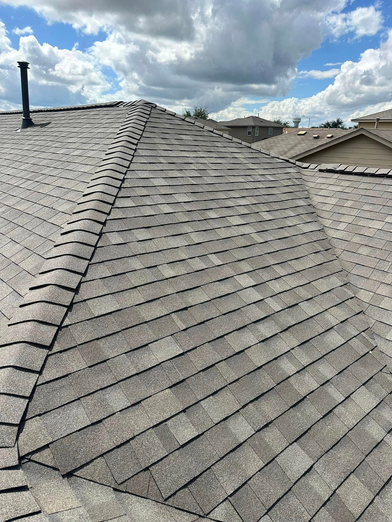 A close up of a roof with a blue sky in the background.