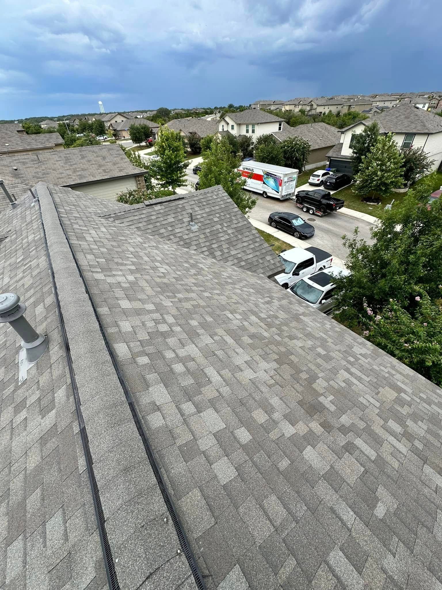 An aerial view of a roof with a lot of cars parked on it.
