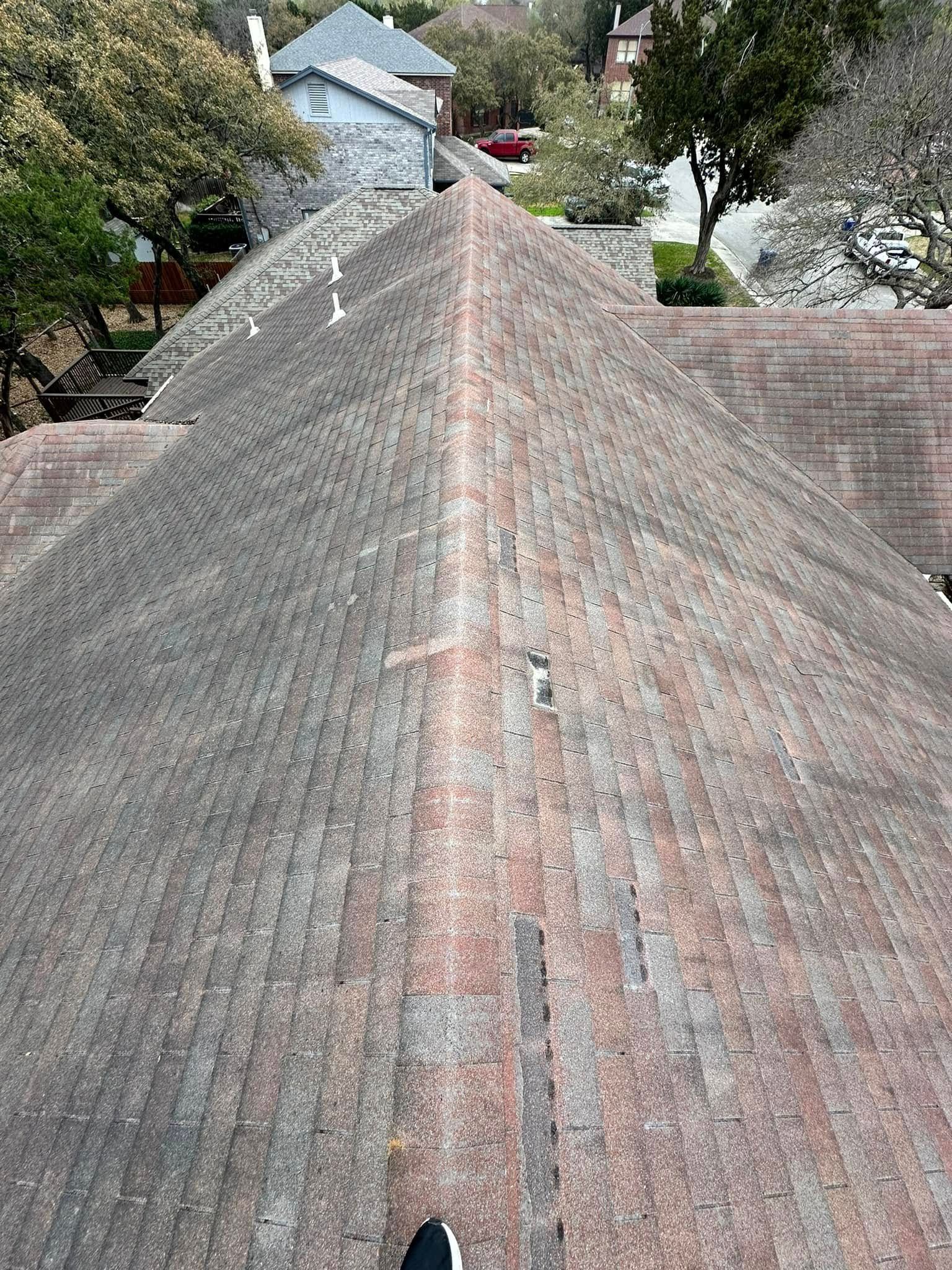 A person is standing on the roof of a house.