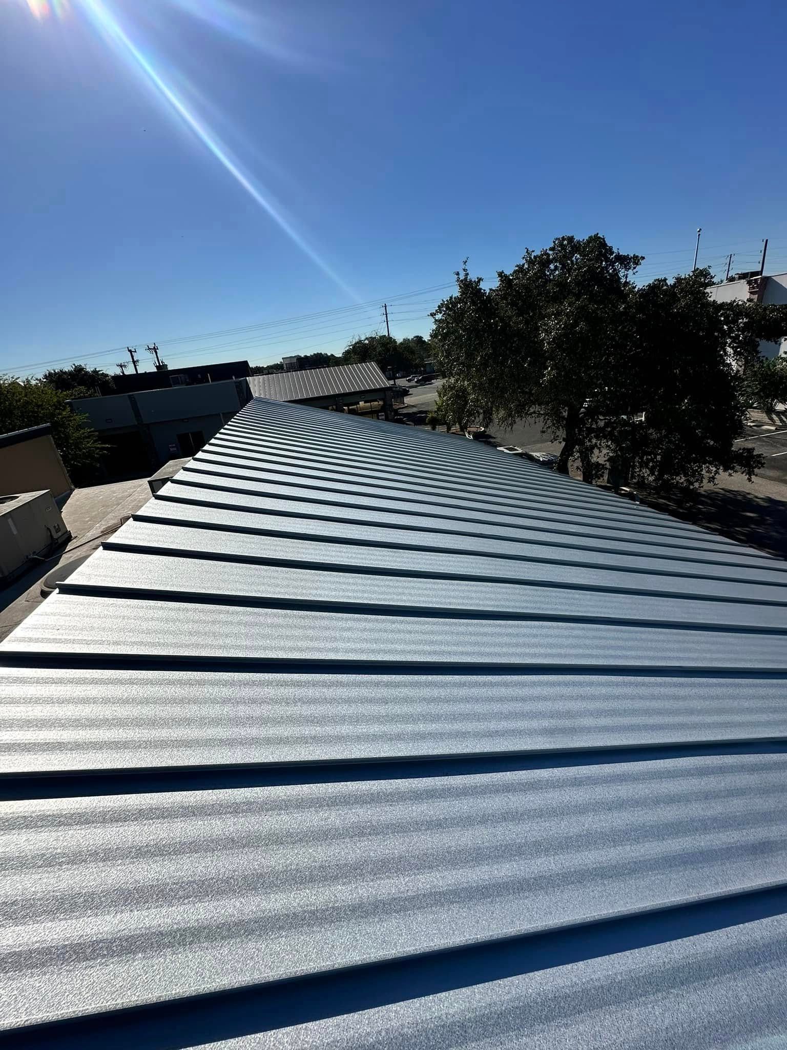 A close up of a roof with a blue sky in the background.