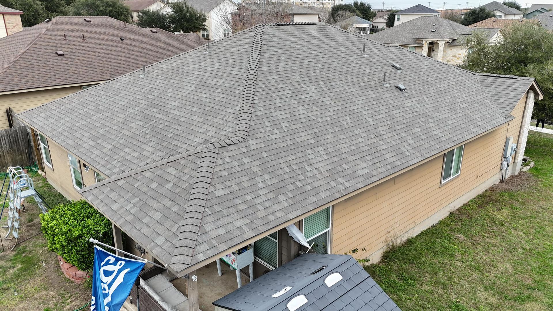 An aerial view of a house with a new roof.