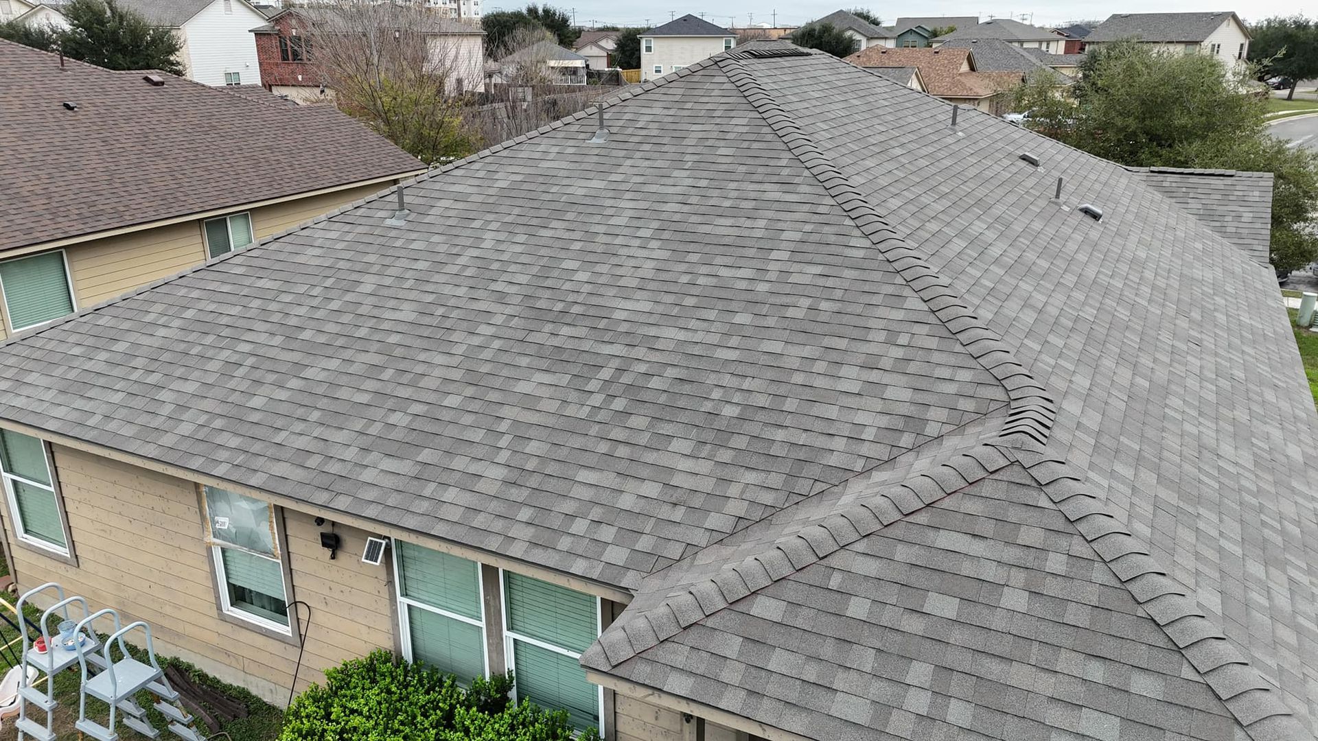 An aerial view of a house with a new roof.