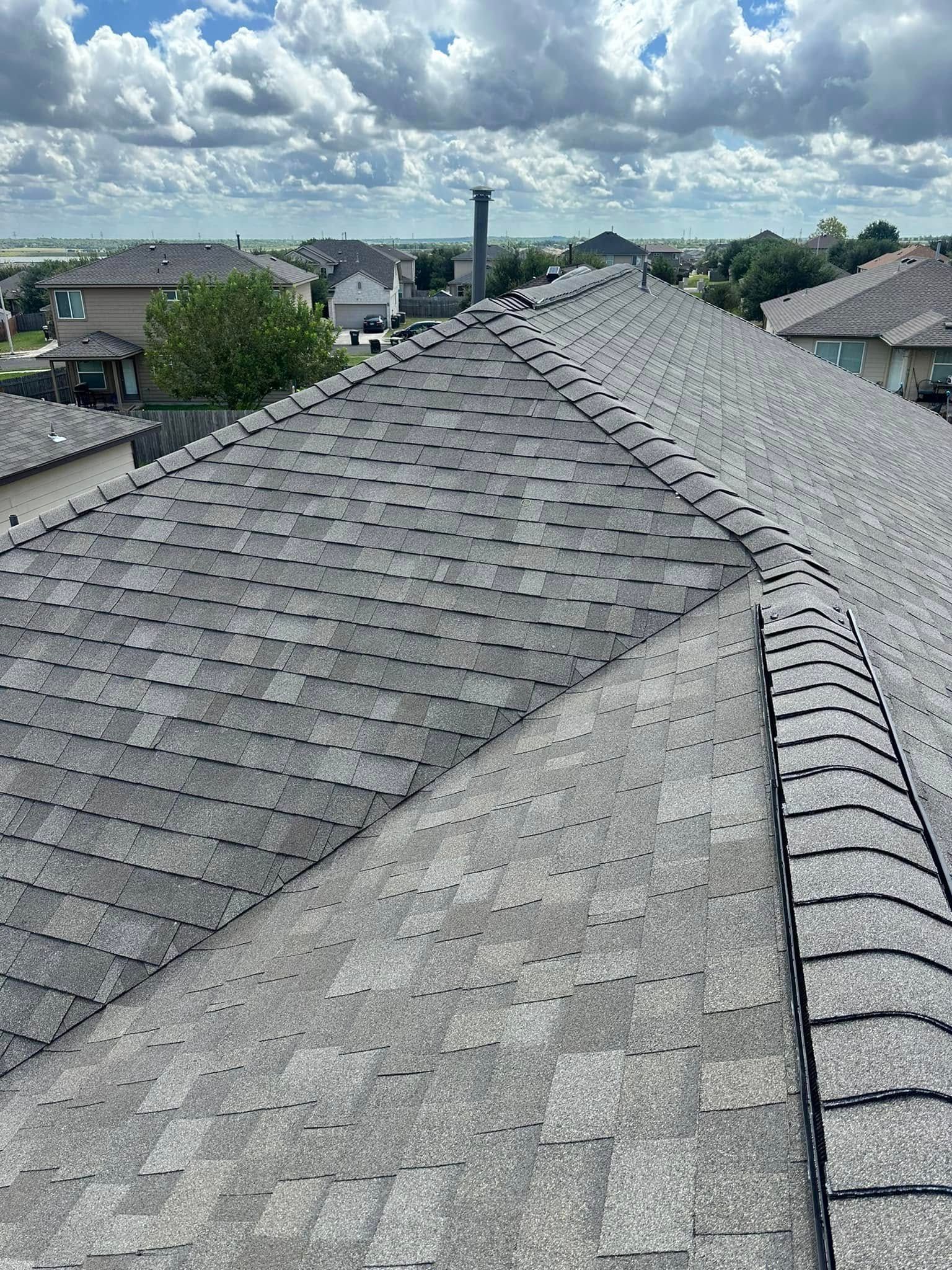 A close up of a roof with a chimney on top of it.