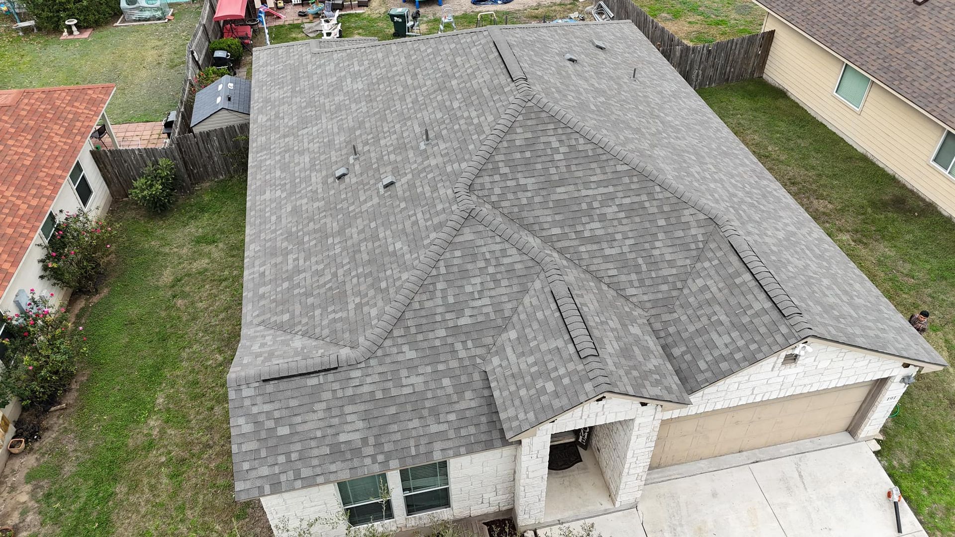 An aerial view of a house with a new roof.