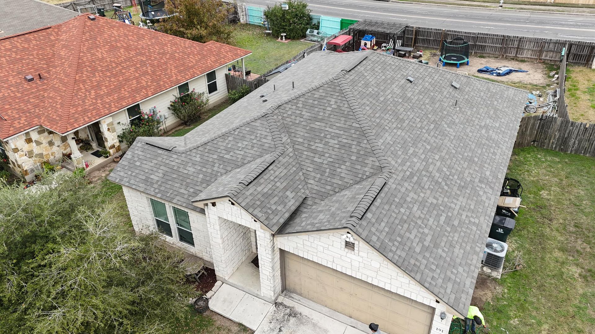 An aerial view of a house with a new roof.