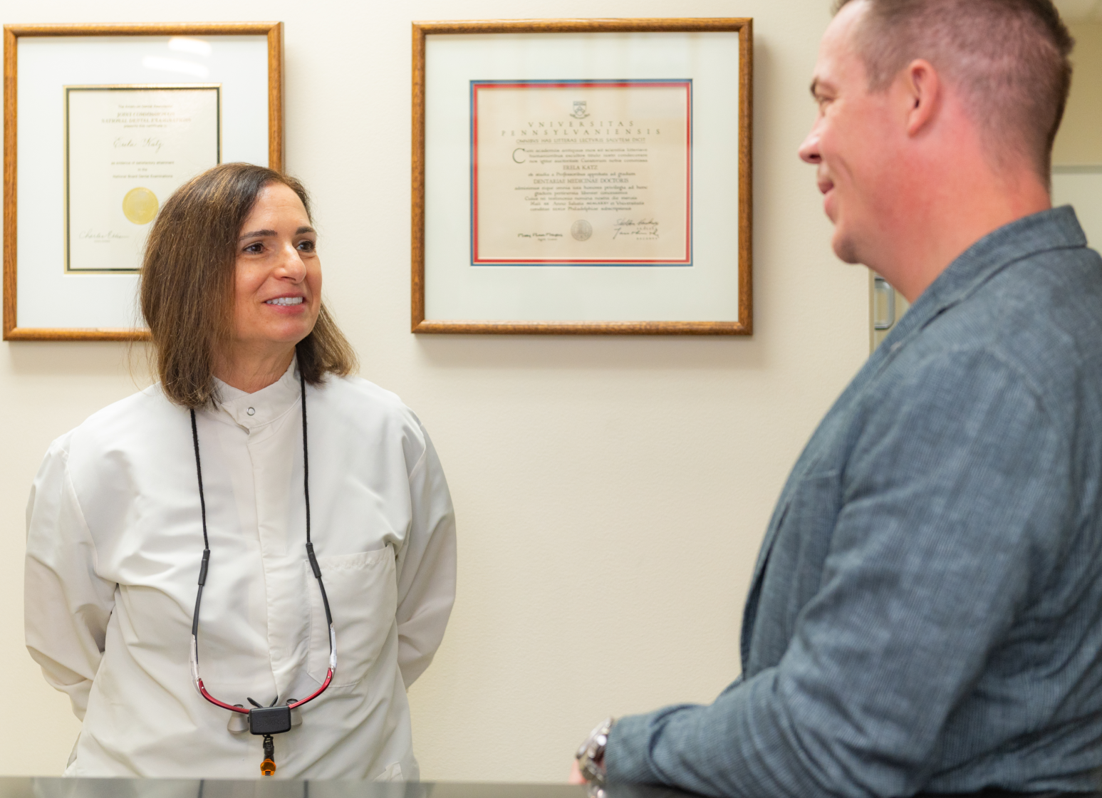 A family is brushing their teeth together in the bathroom.