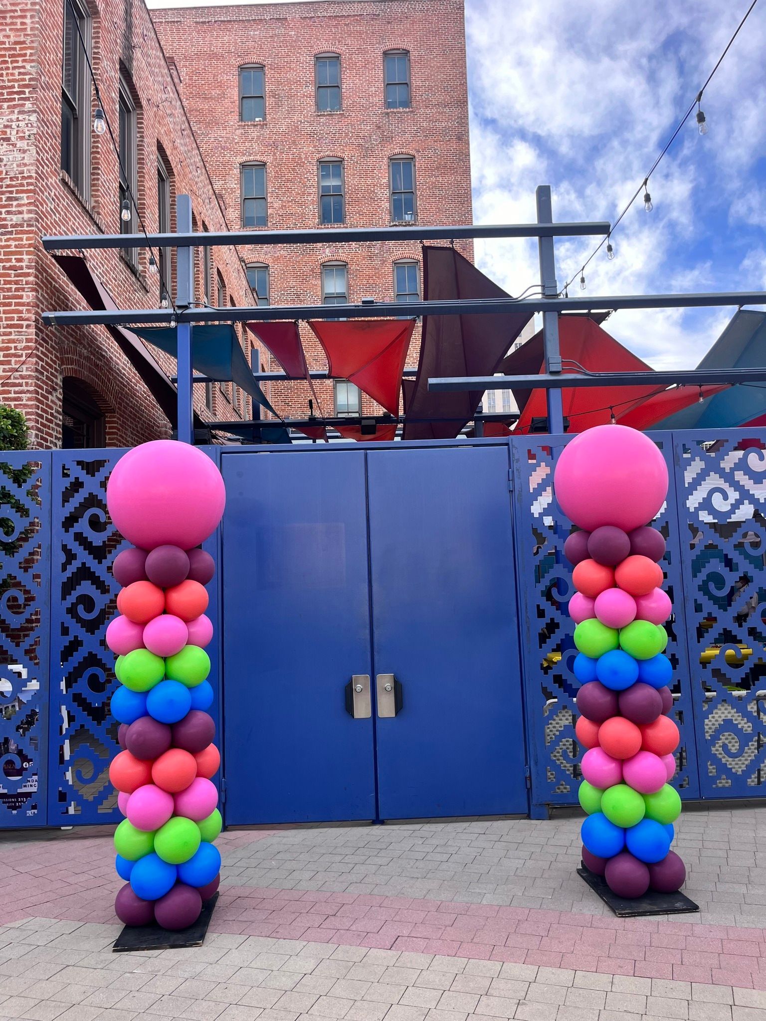 a row of colorful balloons in front of a building