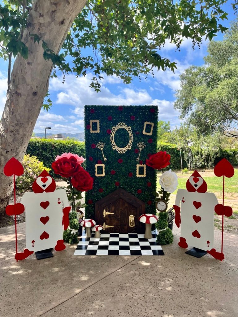 a group of playing cards standing next to each other on a sidewalk