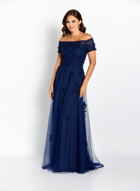 A woman is wearing a blue off the shoulder dress.