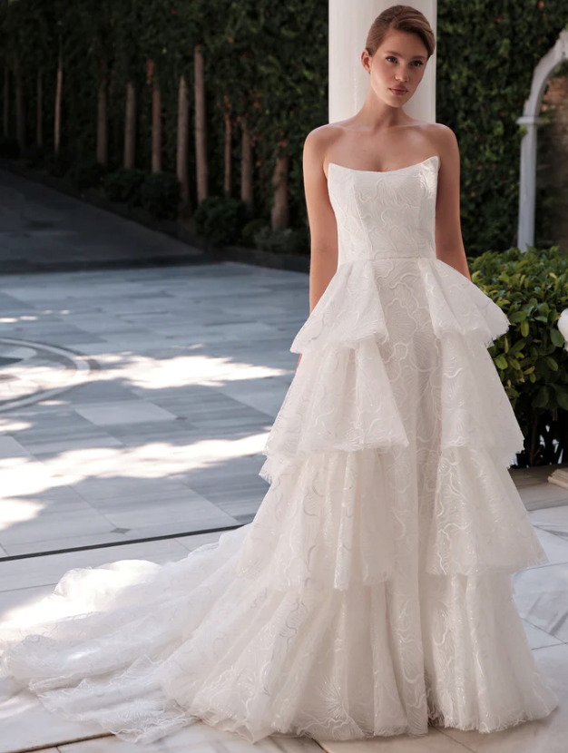 A woman is wearing a white wedding dress with a high slit.