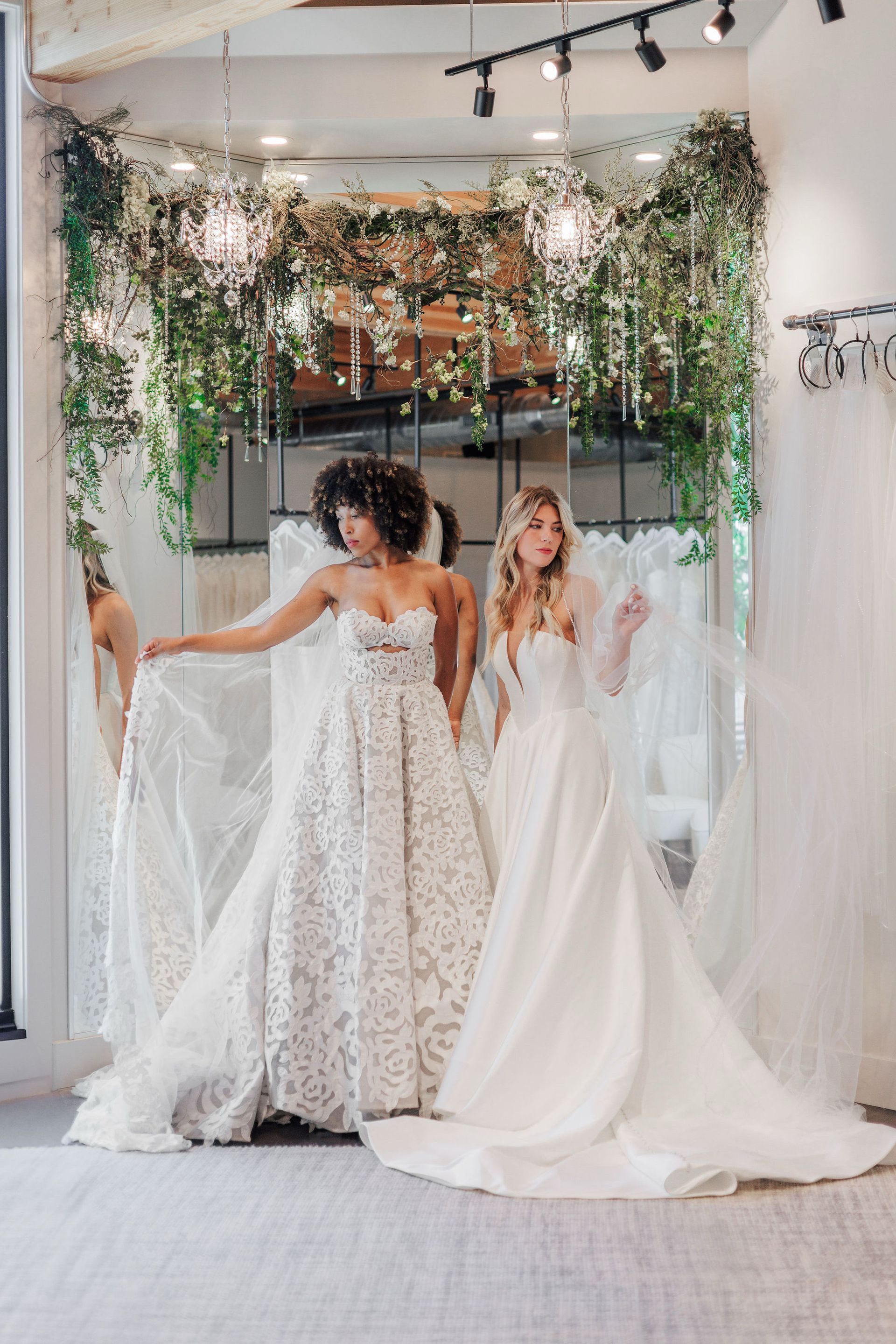 A woman in a wedding dress is standing in a bridal store.