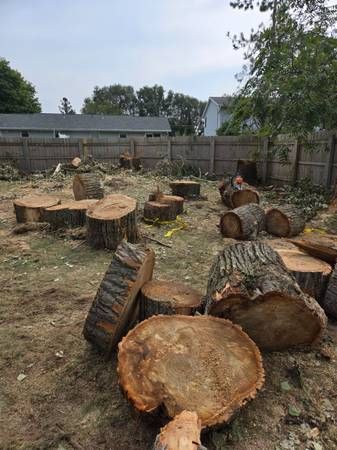 A man is working on a bulldozer on a dirt road.
