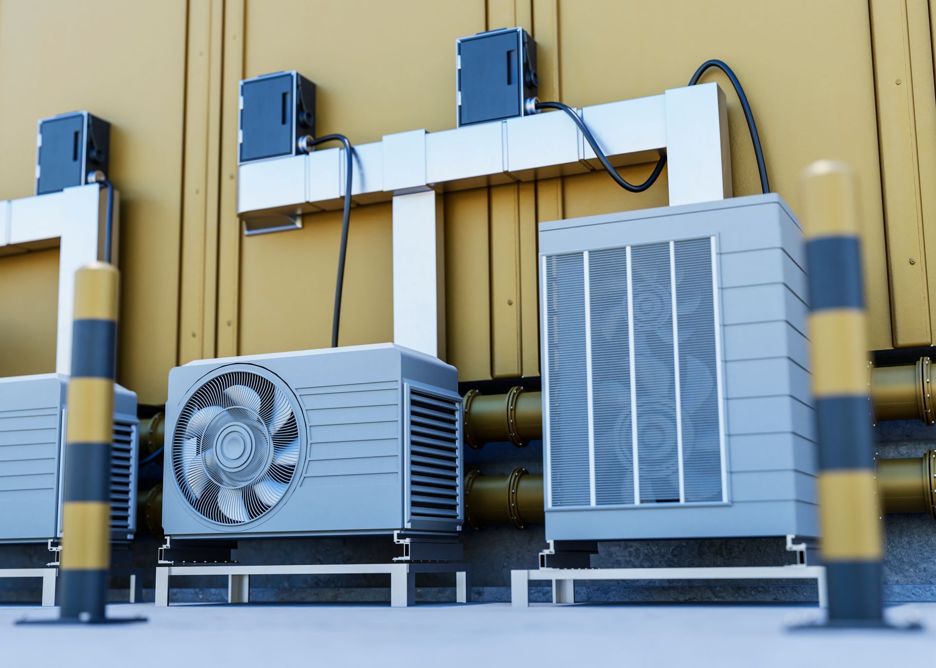 A row of air conditioners are sitting outside of a building.