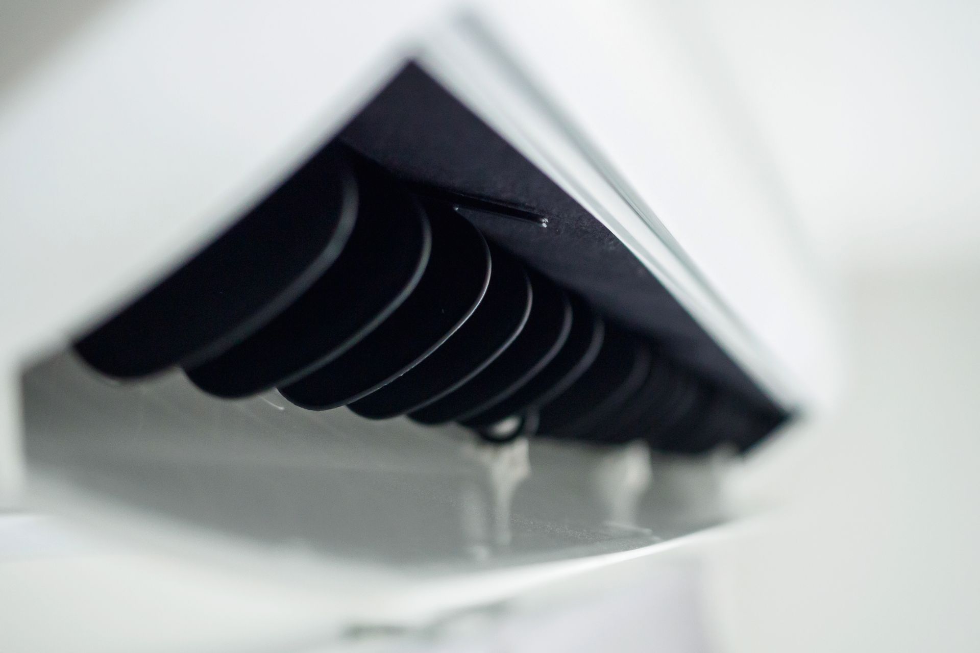 A close up of a white air conditioner with water dripping out of it.