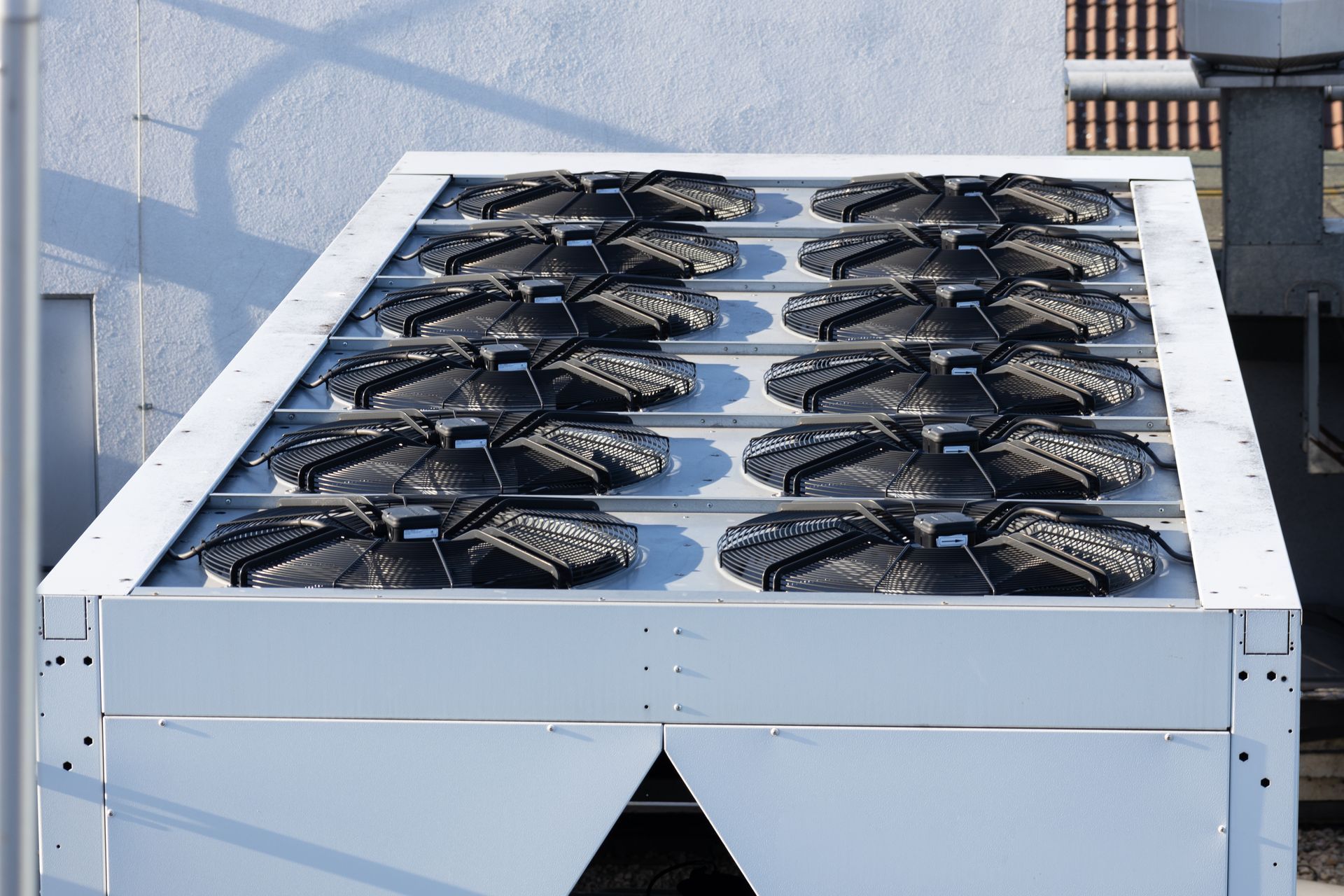 A large metal box with a lot of fans on top of it.