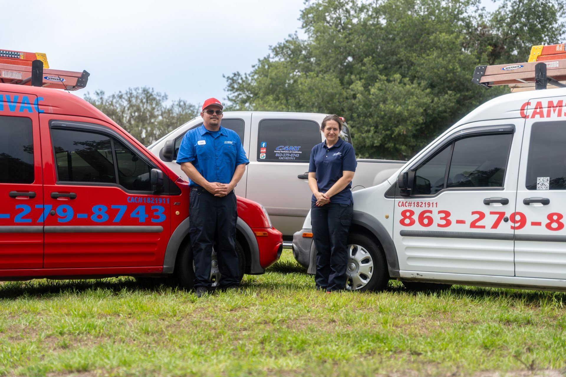 A man is cleaning an air conditioner with a magnifying glass.