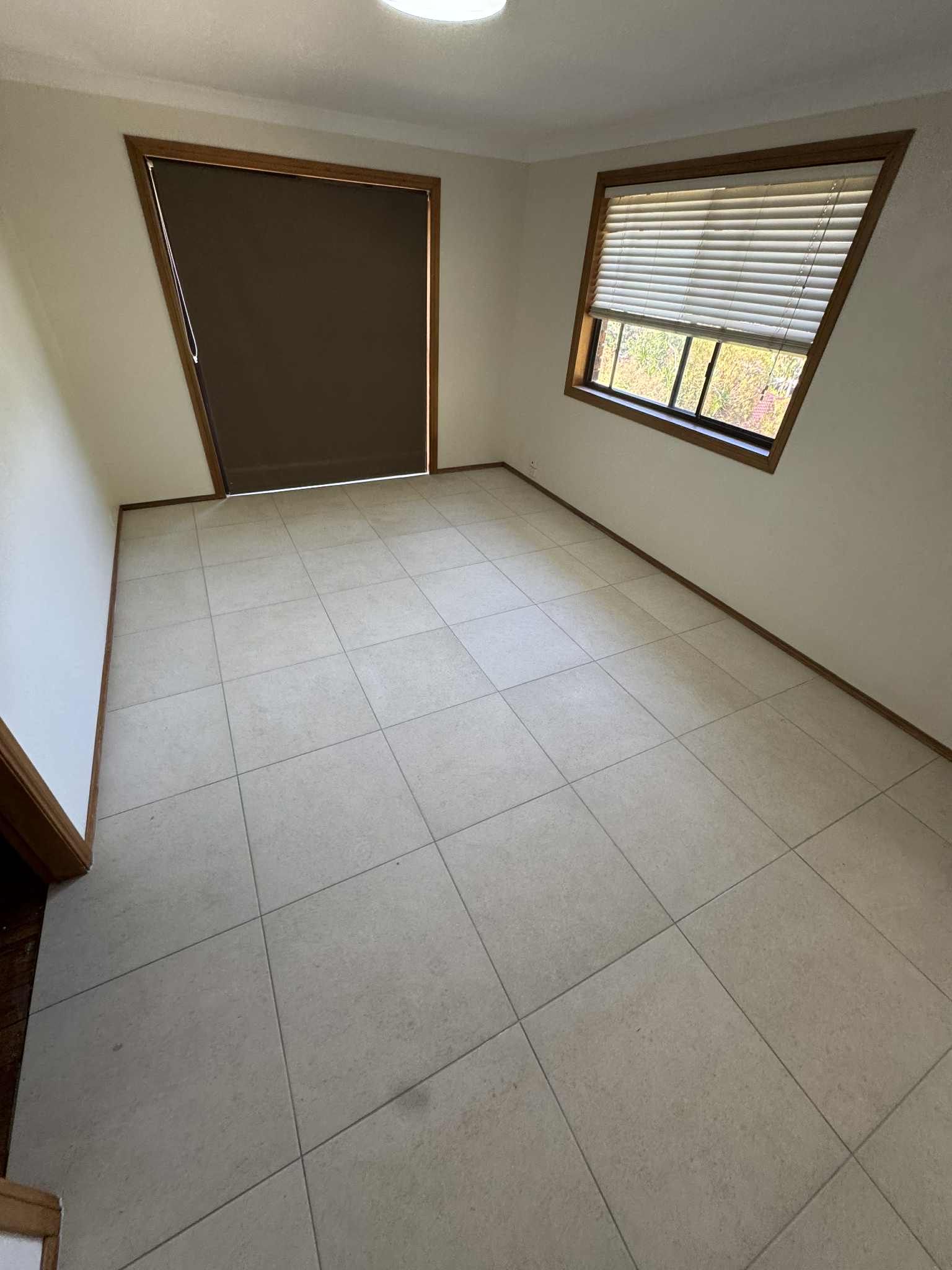 Bathroom with A Black and White Patterned Floor, Tub, and Black Fixtures — Midcoast Wall & Floor Tiling in Woolgoolga, NSW