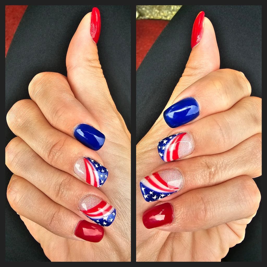 Hands with red, white, and blue nail art, celebrating the Fourth of July.