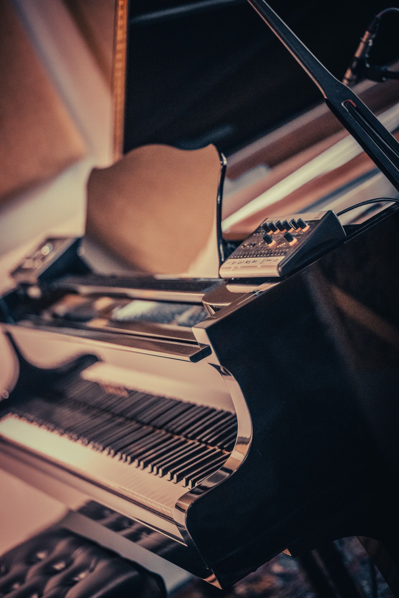 a close up of a piano with a microphone in the background .