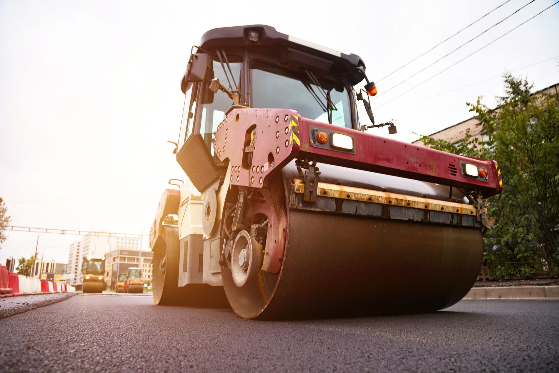 Heavy machinery is used to lay asphalt concrete.