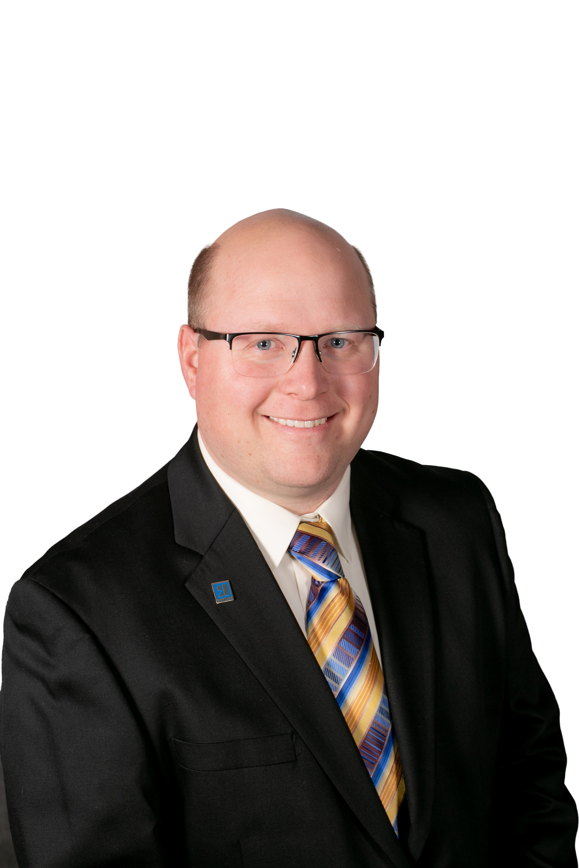 Professional headshot of a bald man